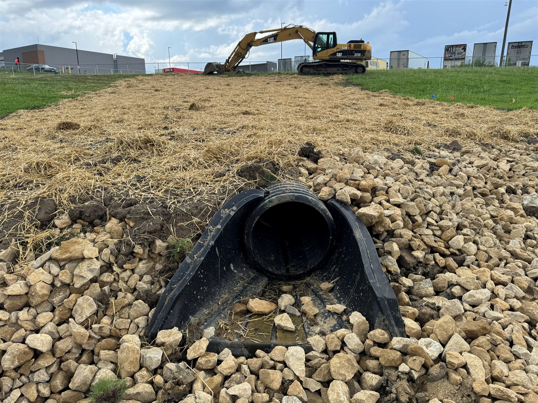 Extended culvert with riprap outlet apron and straw-stabilized ground